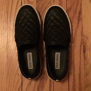 Black Steve Madden slip ons.